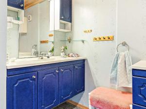 a blue bathroom with a sink and a mirror at Seaside Fisherman s Haven-By Traum in Steinsbø +88 photos