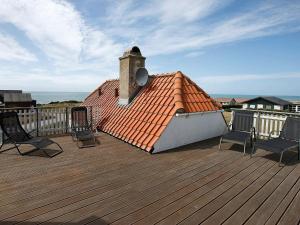 a deck with two chairs and a chimney on a roof at 4 person holiday home in Lemvig in Trans