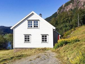 a white house on the side of a hill at Holiday home Masfjordnes in Masfjorden
