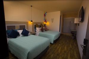 Postel nebo postele na pokoji v ubytování Hotel Aristo Gold