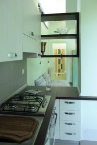 a kitchen with a stove and a counter top at Etna Holiday Home in Nicolosi