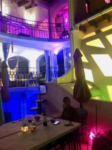 a man sitting at a table in a restaurant at night at Magnolias Boutique Suites & SPA in San Cristóbal de Las Casas