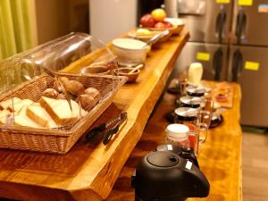 a long wooden counter with a buffet of food at AIBIYA in Yamanouchi