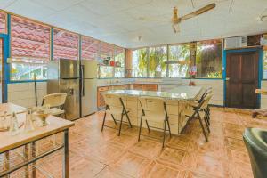 a large kitchen with a table and chairs in it at Villas Maria Luisa in Uvita