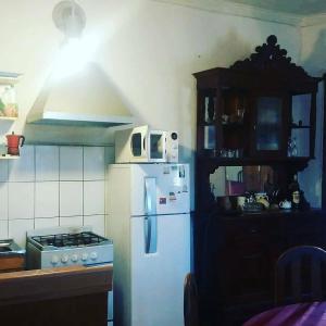 A kitchen or kitchenette at Hostal Cotroneo