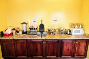 a kitchen with a counter top with a microwave and appliances at Country Hearth Inn-Union City in Union City