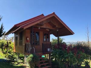 a tiny house with a porch and a staircase at The Memory of Khaokho in Phetchabun