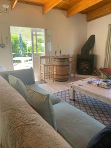 a living room with a couch and a fireplace at Hemel-en-See Beach House in Hermanus