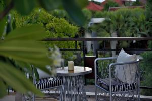 a table and chairs with a candle on a patio at Jaya House River Park in Siem Reap