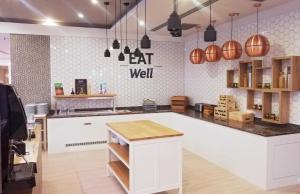 a kitchen with a eat well counter and pendant lights at Holiday Inn Trnava, an IHG Hotel in Trnava