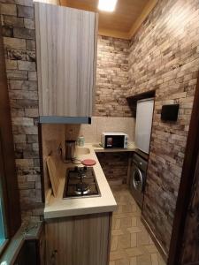 a small kitchen with a stove and a microwave at apartament oriental tale in old cyti Baku in Baku