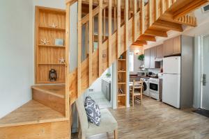 a kitchen and staircase in a tiny house at Sea Breeze Cottages in Ocean Shores