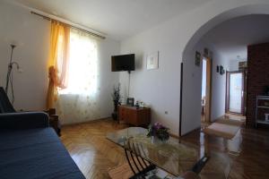 a living room with a woman standing in a window at Apartments Turina in Sveti Juraj
