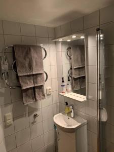 a bathroom with a sink and a shower with towels at Bästa läget i Kalmarsundsparken in Kalmar