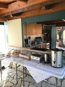 a kitchen with a table with food on it at Villa Agni in Yénion +41 photos