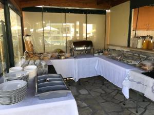 a kitchen with a table with plates and dishes at Villa Agni in Yénion