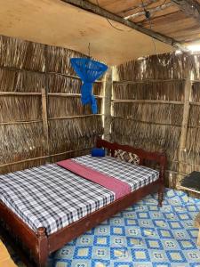 a bed in a room with a blue light at Mida Creek Nature Camp in Watamu
