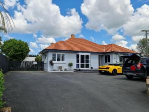 a white house with an orange roof at J&L Boarding Holiday House in Hamilton