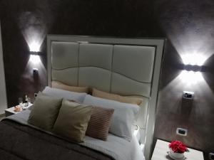 a bedroom with a bed with two lights on it at Royal Dreams in Caserta