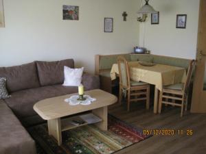a living room with a couch and a table at Ferienwohnung Stilla Traurig in Arrach