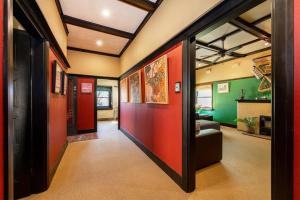 a hallway with red and green walls in a room at Cullalo ArtHouse in Albury