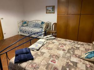 a bedroom with a bed with a quilt on it at Casa Schicciola in Stromboli