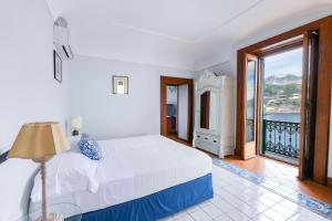 a bedroom with a bed and a view of the ocean at Ravello Art Apartments in Ravello