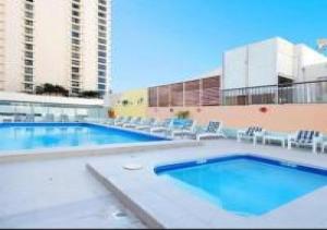 a large swimming pool with chairs and a building at U1 - Relaxing “Seaview’s” from your balcony in Gold Coast
