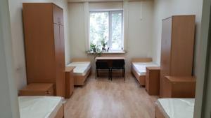 a room with beds and a table and a window at RedLine center in Yekaterinburg