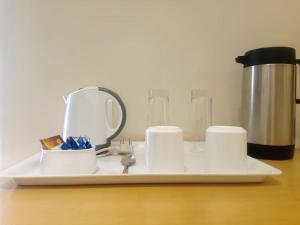 a white tray with cups and a blender on a counter at Mount Manor in Chennai