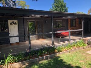 a house with a porch and a deck at Bowral Bungalow in Bowral