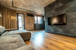 a living room with a couch and a flat screen tv at Квартира в центре Харькова in Kharkiv