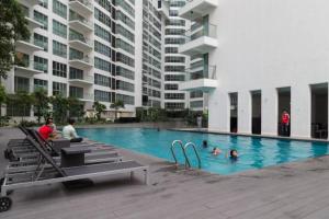 a group of people in a swimming pool in a building at Regalia-Milan in Kuala Lumpur