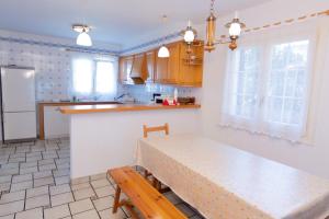 a kitchen with a table and a counter top at VILLA NUEVA II in Cala Galdana +38 photos