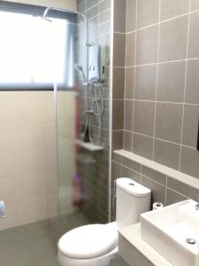 a bathroom with a toilet and a shower and a sink at #6 Summer Studio - One South in Seri Kembangan