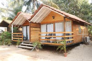 a small wooden house on the beach at Lamarine Morjim Beach cottages in Old Goa +28 photos