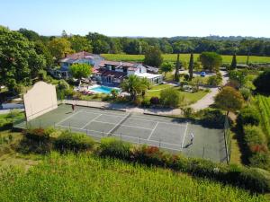 an aerial view of a tennis court in front of a house at Domaine de Millox in Saint-André-de-Seignanx