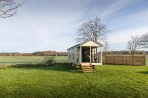 a tiny house in the middle of a field at Stag in Felbrigg