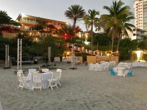 a group of tables and chairs on the beach at CafeGourmetPtaCorona in San Carlos