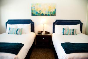 Ein Bett oder Betten in einem Zimmer der Unterkunft Quail Park Lodge