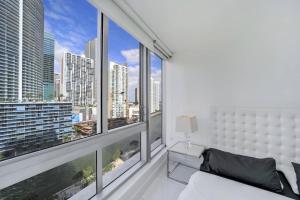 a bedroom with a large window with a view of the city at Icon Brickell Miami in Miami
