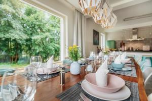 a dining room with a table with plates and glasses at Ferienhaus Fingerhut in Braunlage