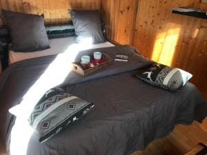 a bed with a tray with two cups on it at LE BLANC NORDIQUE in Le Bouchet-Mont Charvin