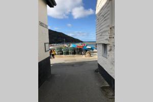 a view of the beach from the side of a building at Molls Yard Traditional Cottage in Port Isaac