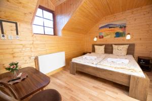 a bedroom with a bed in a wooden cabin at Wellness Penzion Stonozka in Ludvíkov +93 photos