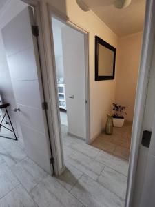 an open door in a room with a tile floor at Departamento en Avenida Del Mar in La Serena