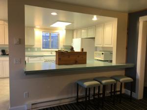 a kitchen with a sink and a counter top at Pacific Reef Hotel & Light Show in Gold Beach