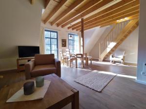 a living room with a couch and a table at Forsthaus Goldberg in Bad Harzburg