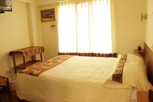 Un pat sau paturi într-o cameră la Picol Hostal