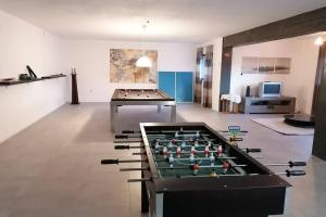 a large room with a pool table and a pool table at Refúgio do Seixoso in Celorico de Basto